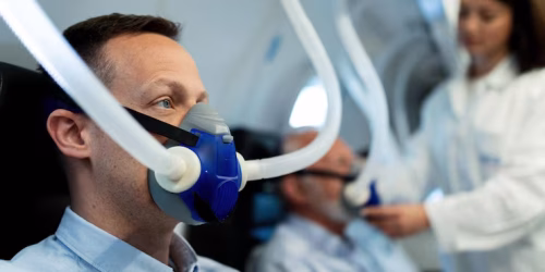 mid-adult-man-breathing-through-mask-hyperbaric-oxygen-therapy-clinic_637285-714