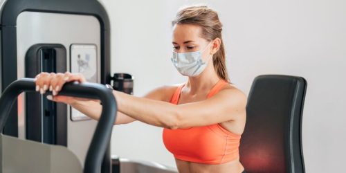 woman-with-mask-working-out-gym_23-2148762603